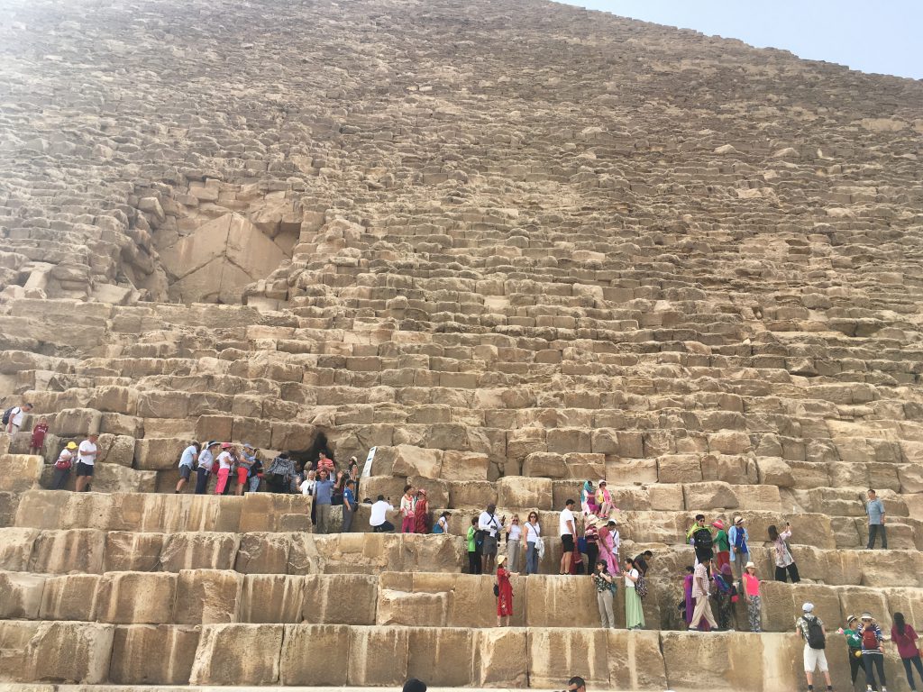 crowds climbing the pyramids